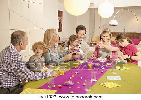 Stock Photo - Family at a birthday celebration. Fotosearch