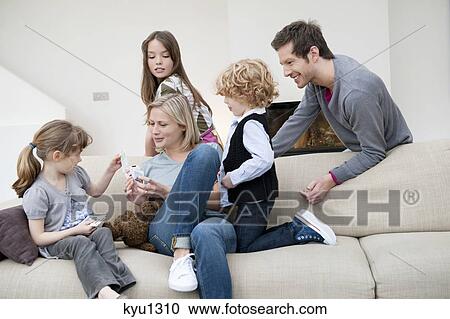 Stock Image - Family in a living room. Fotosearch