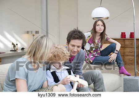 Stock Photo - Family in a living room. Fotosearch