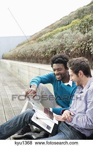 Stock Photo - Friends choosing color swatches. Fotosearch