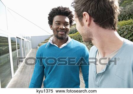 Friends discussing on a boardwalk View Large Photo Image Stock Photography - Friends discussing on a boardwalk. Fotosearch