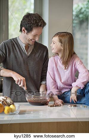 Man stirring a mixture in a bowl with his daughter View Large Photo Image Stock Photography - Man stirring a mixture in a bowl with his daughter. Fotosearch