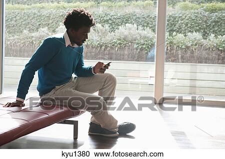 Man text messaging on a mobile phone View Large Photo Image Stock Image - Man text messaging on a mobile phone. Fotosearch
