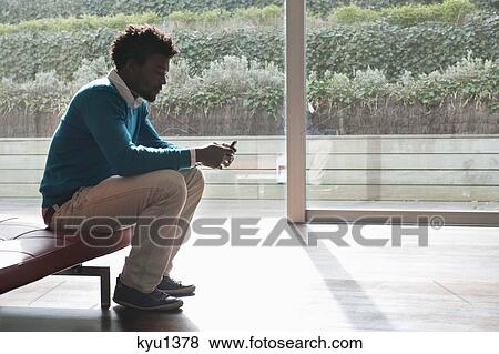 Man text messaging on a mobile phone View Large Photo Image Stock Photo - Man text messaging on a mobile phone. Fotosearch