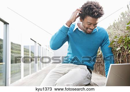 Man using a laptop and looking confused View Large Photo Image Stock Image - Man using a laptop and looking confused. Fotosearch