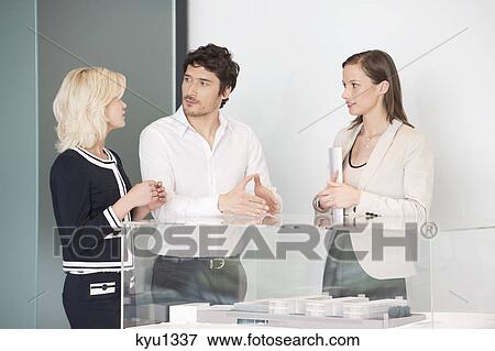 Man with two women near an architectural model View Large Photo Image Stock Photo - Man with two women near an architectural model. Fotosearch