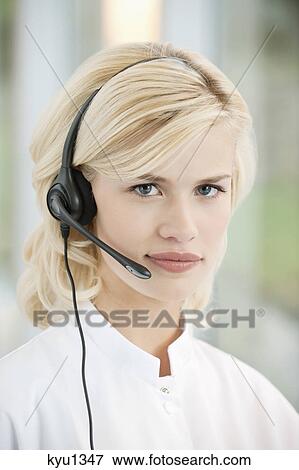 Stock Photo - Portrait of a female customer service representative wearing a headset. Fotosearch