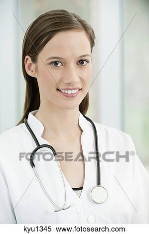 Stock Photography - Portrait of a female doctor smiling. Fotosearch