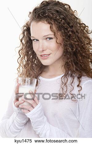 Stock Photography - Portrait of a woman holding a glass of milk. Fotosearch