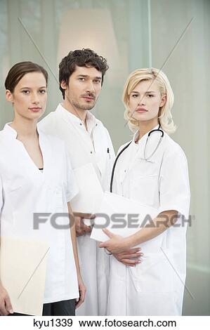 Portrait of three doctors standing together View Large Photo Image Stock Photo - Portrait of three doctors standing together. Fotosearch