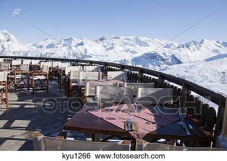 Restaurant terrace surrounded by snow covered mountains View Large Photo Image Stock Photograph - Restaurant terrace surrounded by snow covered mountains. Fotosearch