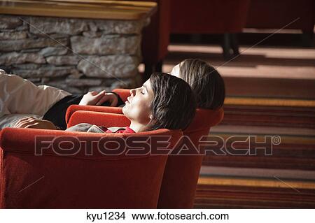 Two women resting in armchairs View Large Photo Image Picture - Two women resting in armchairs. Fotosearch