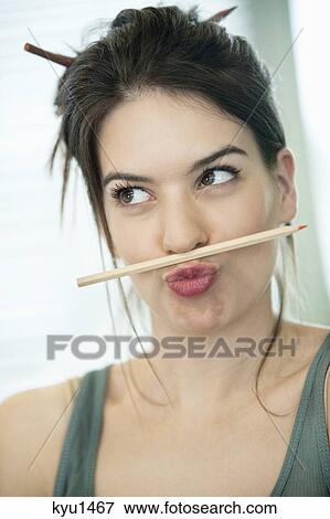 Woman balancing a pencil on lip View Large Photo Image Stock Photo - Woman balancing a pencil on lip. Fotosearch