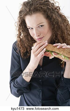 Woman eating a sandwich View Large Photo Image Stock Image - Woman eating a sandwich. Fotosearch