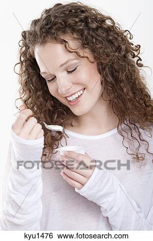 Woman eating yogurt View Large Photo Image Stock Photograph - Woman eating yogurt. Fotosearch