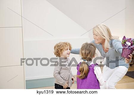 Woman greeting her grandchildren View Large Photo Image Stock Photo - Woman greeting her grandchildren. Fotosearch