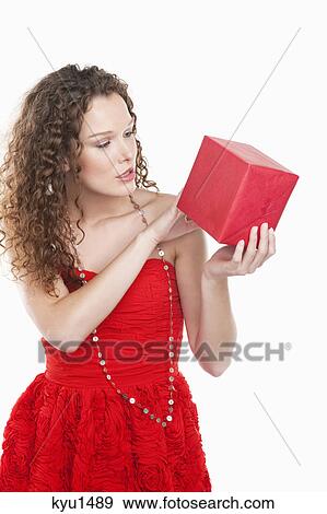 Woman looking at a present View Large Photo Image Stock Photo - Woman looking at a present. Fotosearch