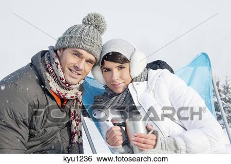 Young couple in ski wear resting View Large Photo Image Stock Photograph - Young couple in ski wear resting. Fotosearch