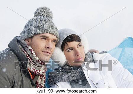 Young couple in winter clothes embracing View Large Photo Image Stock Photo - Young couple in winter clothes embracing. Fotosearch