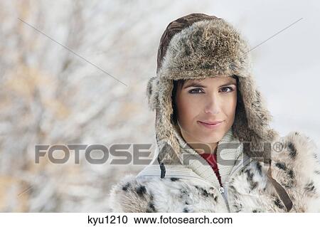 Stock Image - Young woman in winter clothes looking at camera. Fotosearch