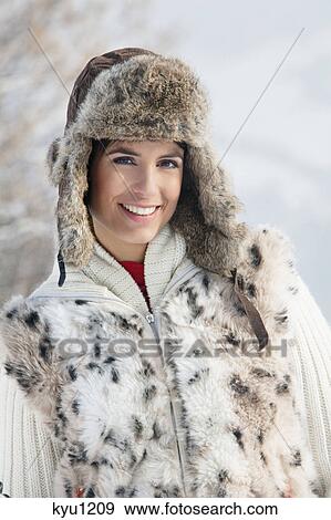Stock Photo - Young woman in winter clothes smiling at camera. Fotosearch