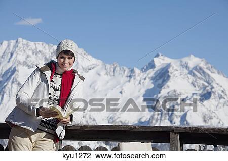 Young woman reading a book, enjoying winter sun, mountains in background View Large Photo Image Stock Image - Young woman reading a book, enjoying winter sun, mountains in background. Fotosearch