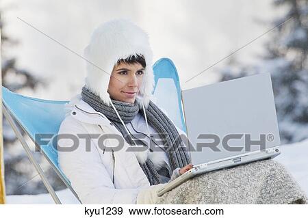 Young woman using laptop computer in snow View Large Photo Image Stock Photo - Young woman using laptop computer in snow. Fotosearch