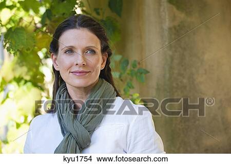 Beautiful mature woman day dreaming View Large Photo Image Picture - Beautiful mature woman day dreaming. Fotosearch