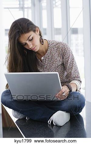 Beautiful woman using a laptop View Large Photo Image Stock Photo - Beautiful woman using a laptop. Fotosearch