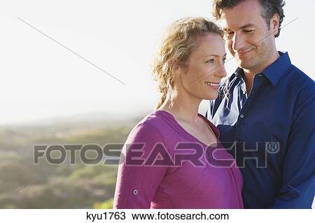 Close-up of a couple smiling View Large Photo Image Stock Image - Close-up of a couple smiling. Fotosearch