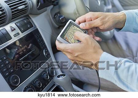 Close-up of human hand using GPS navigation system in car View Large Photo Image Picture - Close-up of human hand using GPS navigation system in car. Fotosearch