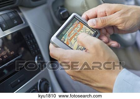 Close-up of human hand using GPS navigation system in car View Large Photo Image Stock Image - Close-up of human hand using GPS navigation system in car. Fotosearch