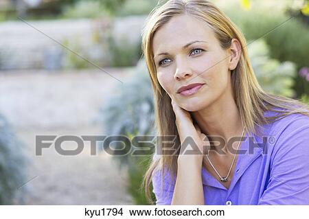 Contemplative young woman looking away with hand on chin View Large Photo Image Picture - Contemplative young woman looking away with hand on chin. Fotosearch