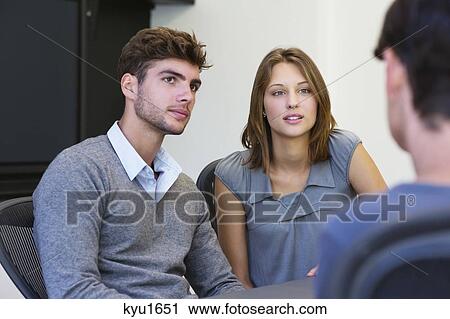 Couple meeting with an advisor View Large Photo Image Stock Image - Couple meeting with an advisor. Fotosearch