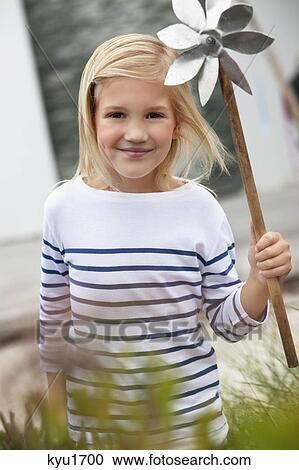 Cute girl holding pinwheel View Large Photo Image Stock Image - Cute girl holding pinwheel. Fotosearch