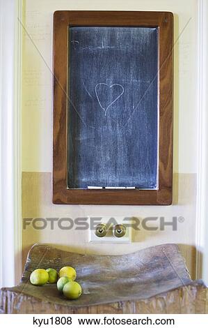 Stock Photo - Details of blackboard with fruits kept on wooden stand. Fotosearch