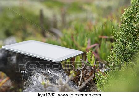 Digital tablet on rock View Large Photo Image Stock Image - Digital tablet on rock. Fotosearch