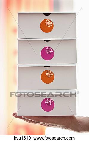 Human hand holding cake boxes in a restaurant View Large Photo Image Stock Photo - Human hand holding cake boxes in a restaurant. Fotosearch
