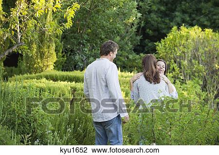 Mature couple hugging their mother in a garden View Large Photo Image Stock Image - Mature couple hugging their mother in a garden. Fotosearch