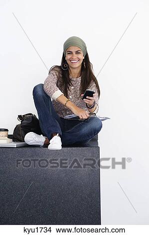 Portrait of a beautiful woman using mobile against white background View Large Photo Image Picture - Portrait of a beautiful woman using mobile against white background. Fotosearch