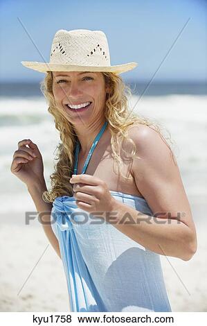 Portrait of a beautiful woman wearing sunhat and smiling View Large Photo Image Stock Photo - Portrait of a beautiful woman wearing sunhat and smiling. Fotosearch
