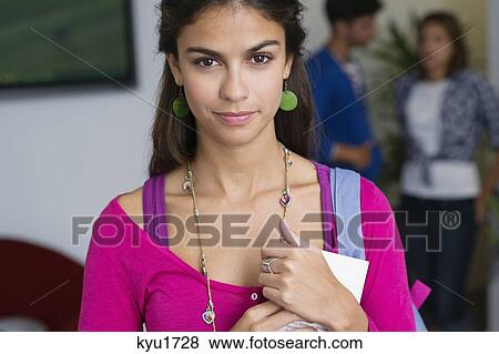 Portrait of a female university student holding a book View Large Photo Image Stock Photo - Portrait of a female university student holding a book. Fotosearch