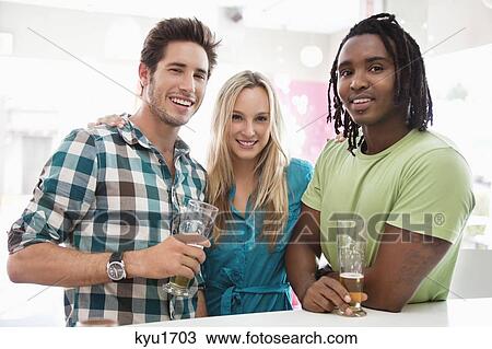 Portrait of friends having beer at a bar View Large Photo Image Stock Image - Portrait of friends having beer at a bar. Fotosearch