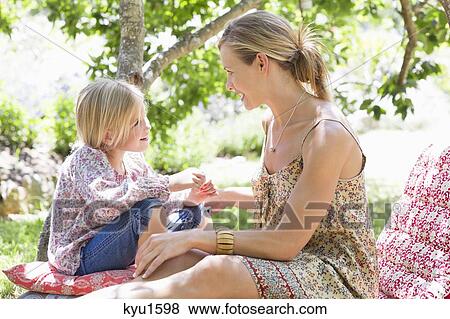 Side profile of mother and a little girl looking to each other outdoors View Large Photo Image Stock Photo - Side profile of mother and a little girl looking to each other outdoors. Fotosearch