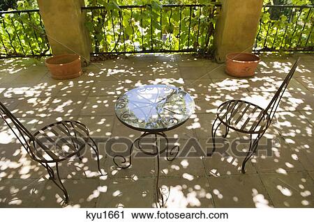 Stock Image - Table and chairs in a veranda. Fotosearch