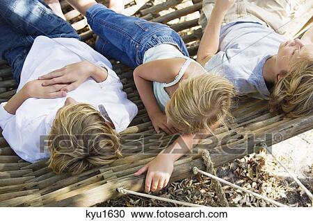 Tired little siblings sleeping in hammock View Large Photo Image Stock Image - Tired little siblings sleeping in hammock. Fotosearch