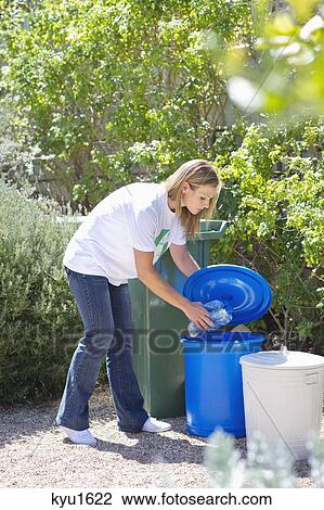 Woman throwing water bottles in garbage bin View Large Photo Image Stock Image - Woman throwing water bottles in garbage bin. Fotosearch
