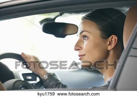 Stock Photo - Young woman taking a test drive. Fotosearch