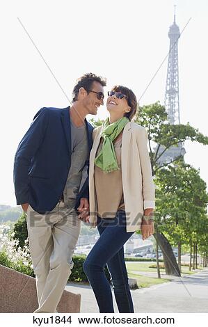 Picture - Couple moving up steps with the Eiffel Tower in the background, Paris, Ile-de-France, France. Fotosearch
