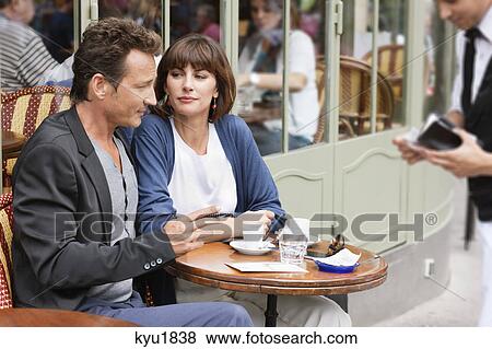 Couple sitting in a restaurant, Paris, Ile-de-France, France View Large Photo Image Stock Photo - Couple sitting in a restaurant, Paris, Ile-de-France, France. Fotosearch
